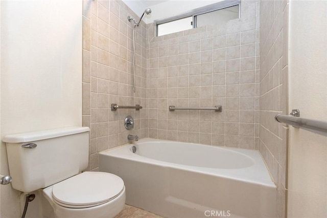 bathroom featuring tiled shower / bath combo and toilet