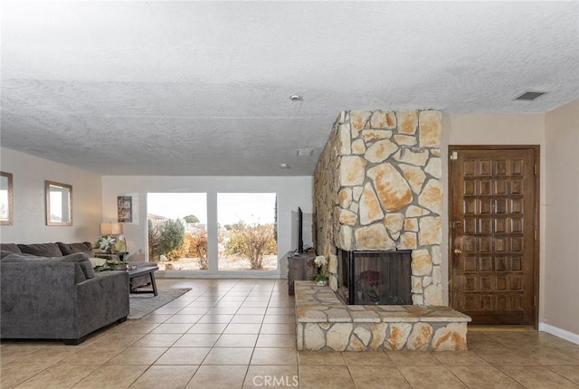 tiled living room with a fireplace and a textured ceiling