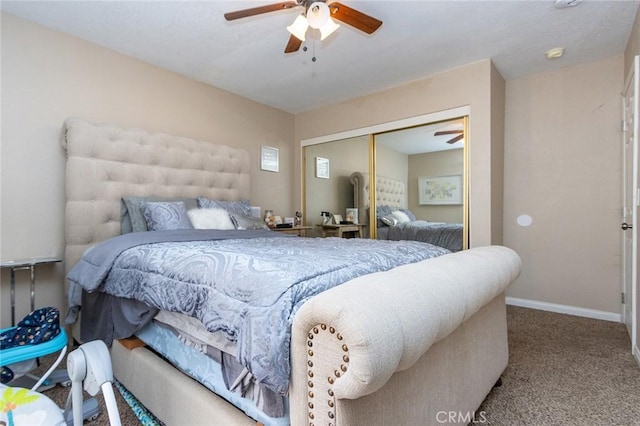 carpeted bedroom featuring ceiling fan and a closet