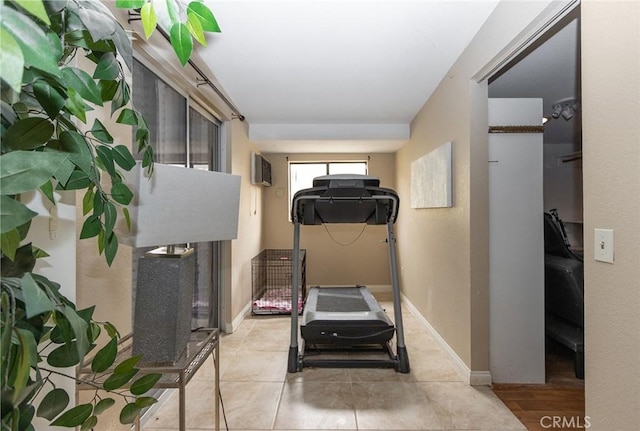 workout area with light hardwood / wood-style floors