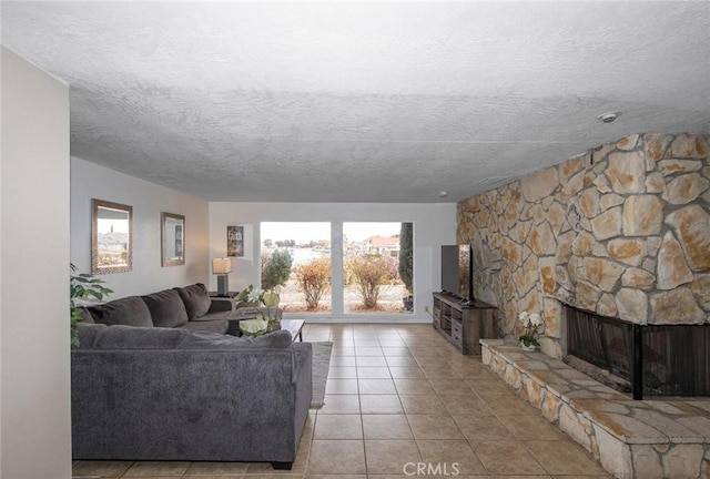 tiled living room with a fireplace and a textured ceiling