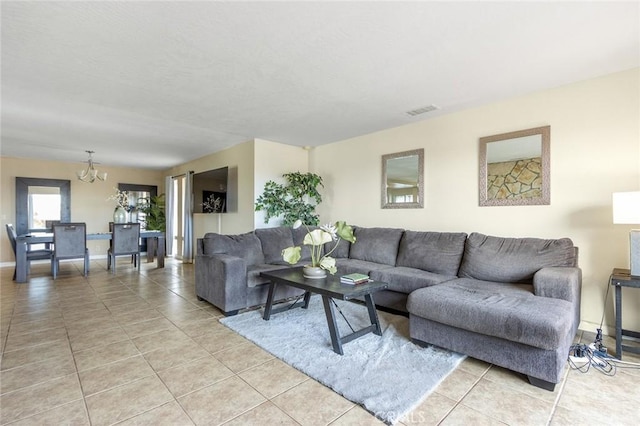 living room with light tile patterned floors and a notable chandelier