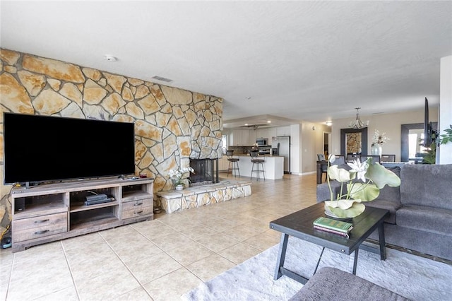 living room featuring a fireplace and light tile patterned floors