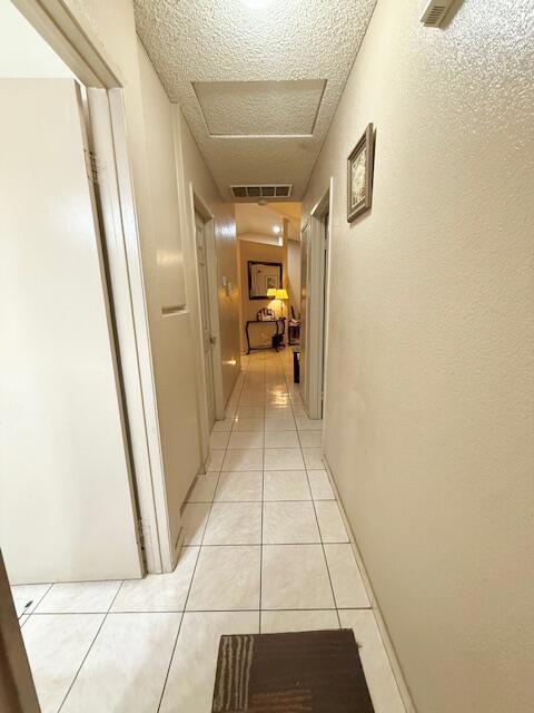 hall with light tile patterned flooring