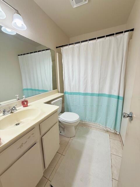 bathroom featuring tile patterned floors, vanity, and toilet