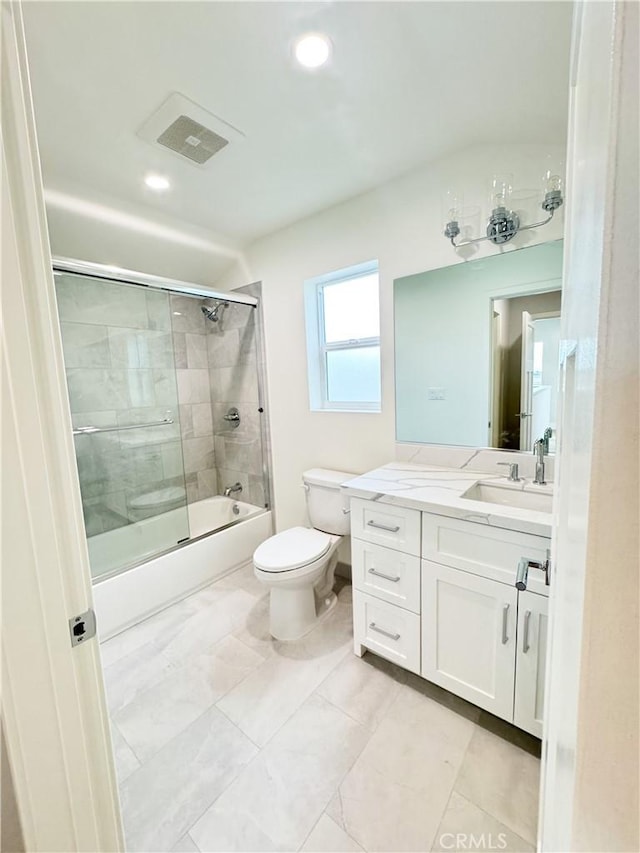 full bathroom with vanity, bath / shower combo with glass door, and toilet