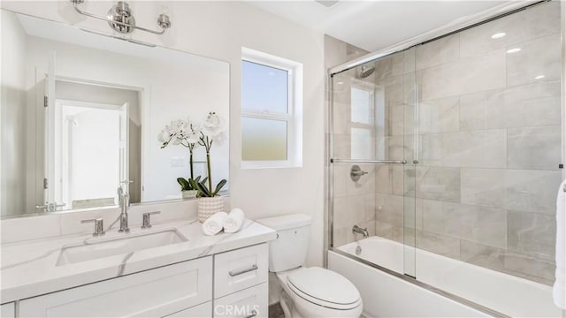 full bathroom featuring vanity, toilet, and enclosed tub / shower combo