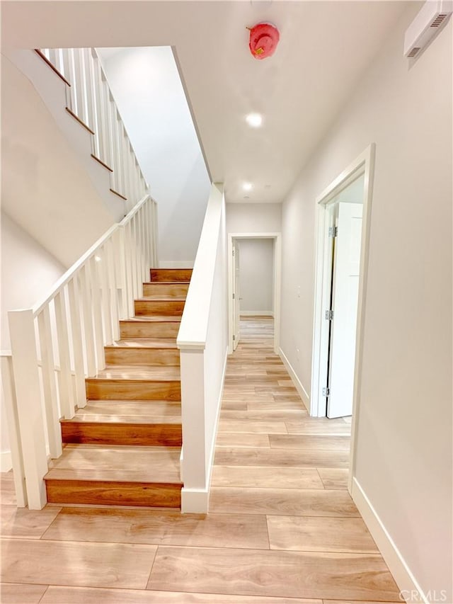 staircase with hardwood / wood-style flooring