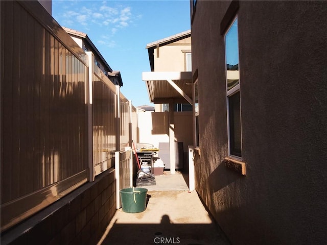 view of side of home with a patio area