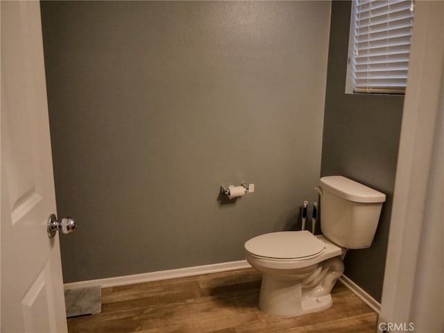 bathroom featuring wood-type flooring and toilet