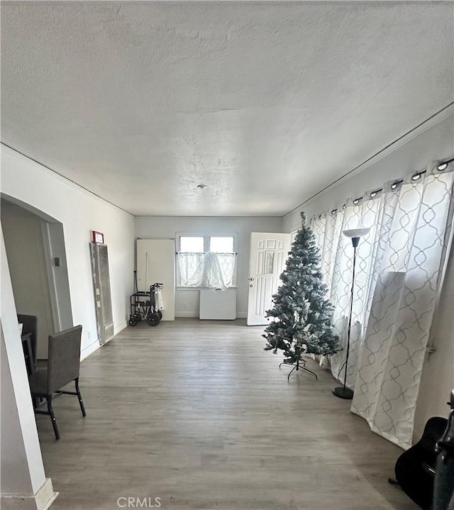 interior space with hardwood / wood-style flooring and a textured ceiling