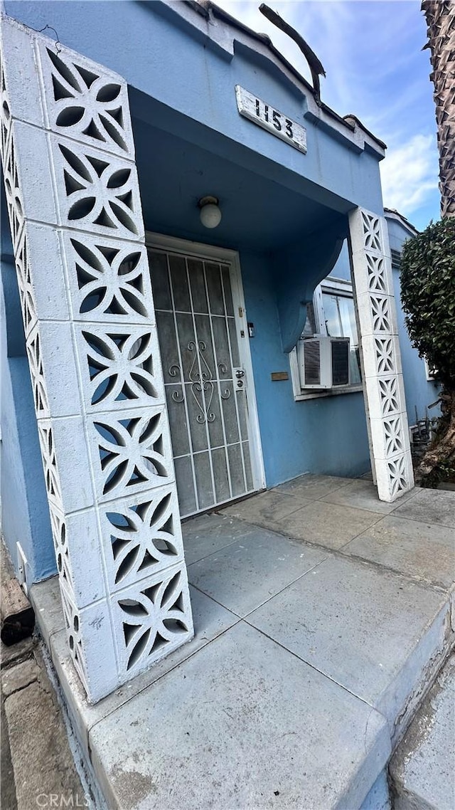 doorway to property with cooling unit