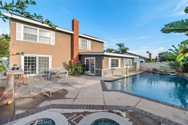 view of pool with an outdoor fire pit and a patio