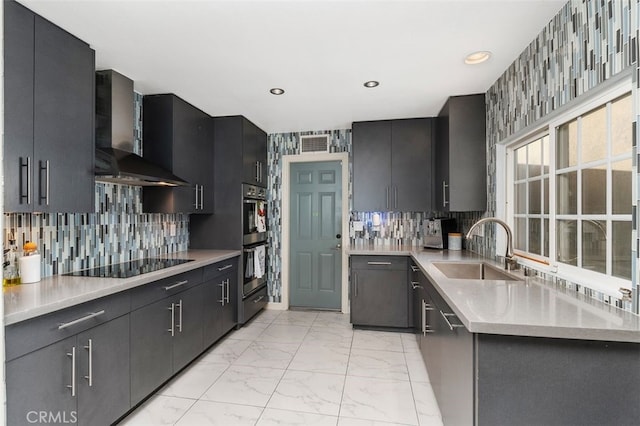 kitchen with sink, backsplash, wall chimney exhaust hood, and black appliances