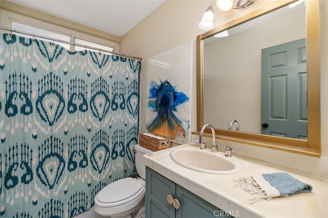 bathroom with vanity, a shower with shower curtain, and toilet