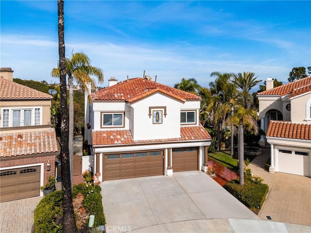 mediterranean / spanish house with a garage