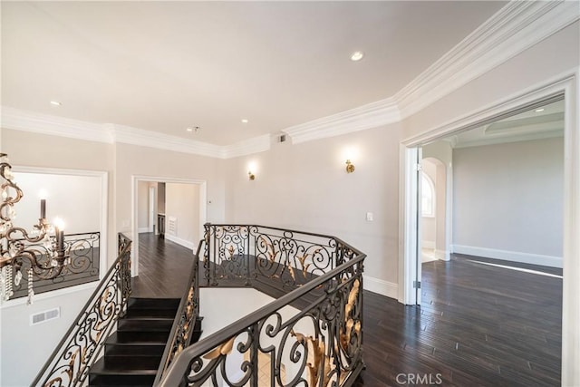 hallway with dark hardwood / wood-style floors and ornamental molding