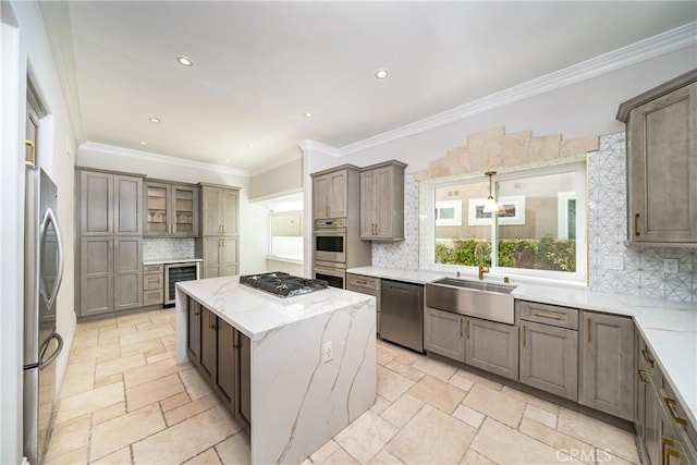 kitchen featuring sink, decorative backsplash, appliances with stainless steel finishes, a kitchen island, and beverage cooler