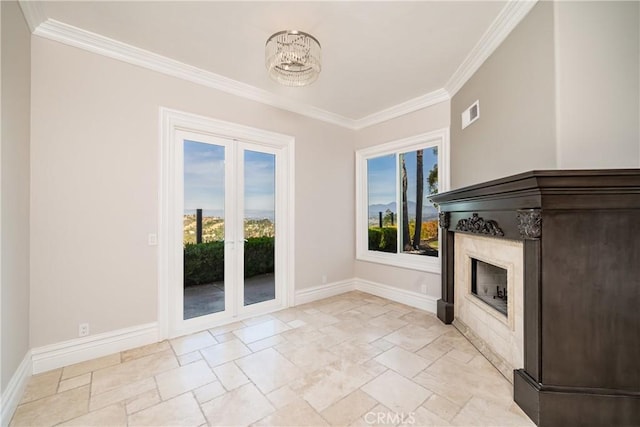 unfurnished living room featuring a chandelier, ornamental molding, and a healthy amount of sunlight