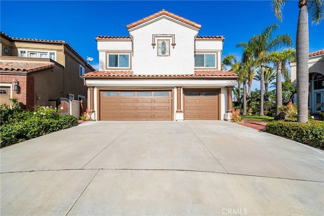 mediterranean / spanish house featuring a garage