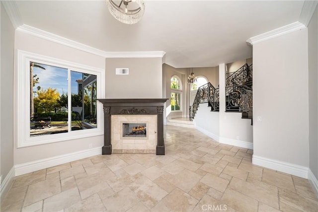 unfurnished living room with an inviting chandelier, a healthy amount of sunlight, and crown molding