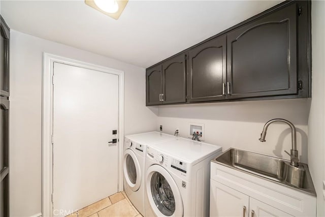 clothes washing area featuring light tile patterned flooring, cabinets, independent washer and dryer, and sink