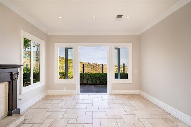 interior space featuring a high end fireplace and ornamental molding