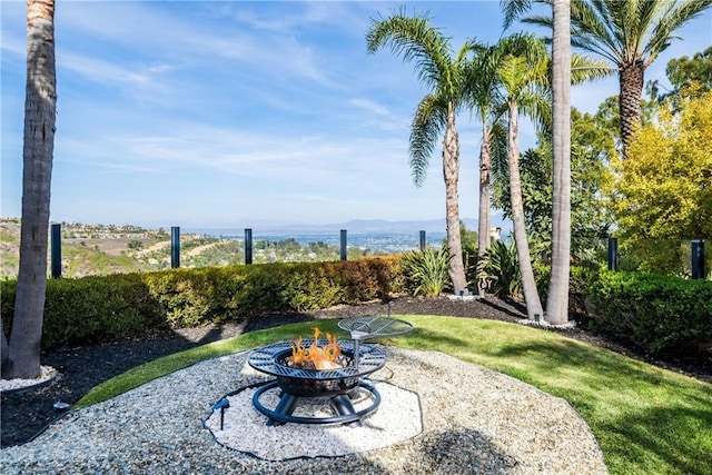 view of yard featuring an outdoor fire pit and a patio