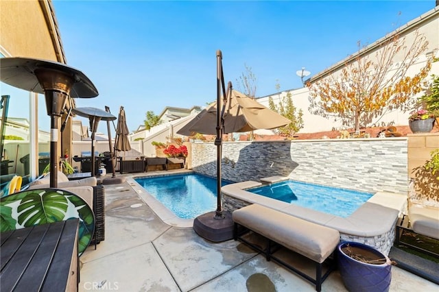 view of pool with an in ground hot tub, a patio, a fenced backyard, and a fenced in pool