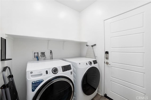 laundry area with wood-type flooring and independent washer and dryer