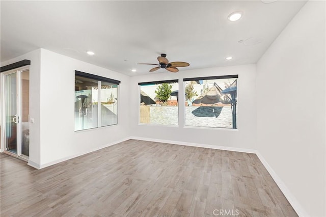 empty room featuring ceiling fan and light hardwood / wood-style floors