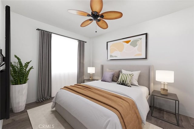 bedroom with wood-type flooring and ceiling fan