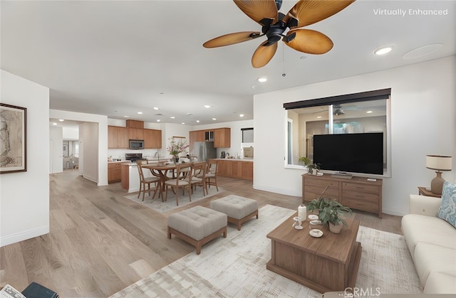 living area featuring light wood-type flooring, ceiling fan, baseboards, and recessed lighting