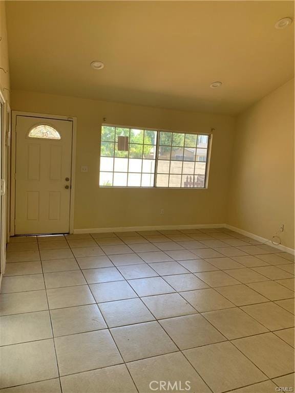 foyer featuring plenty of natural light and light tile patterned floors