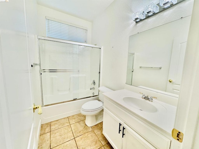 full bathroom with tile patterned floors, vanity, enclosed tub / shower combo, and toilet