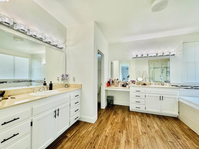 full bathroom featuring hardwood / wood-style floors, vanity, toilet, and plus walk in shower