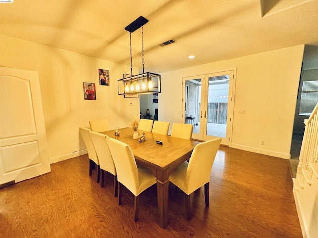 dining space with hardwood / wood-style flooring and french doors