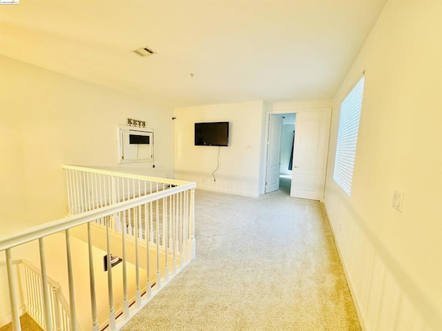 hallway featuring light carpet