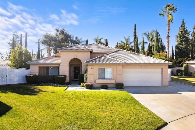 mediterranean / spanish house featuring a front yard and a garage