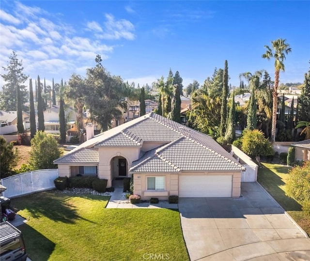 mediterranean / spanish-style house featuring a front lawn and a garage