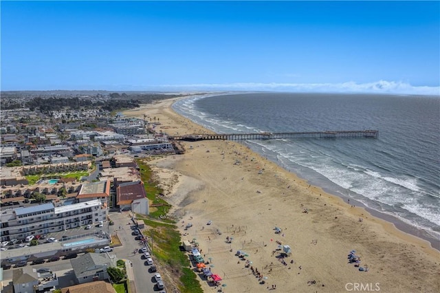 aerial view with a water view and a beach view