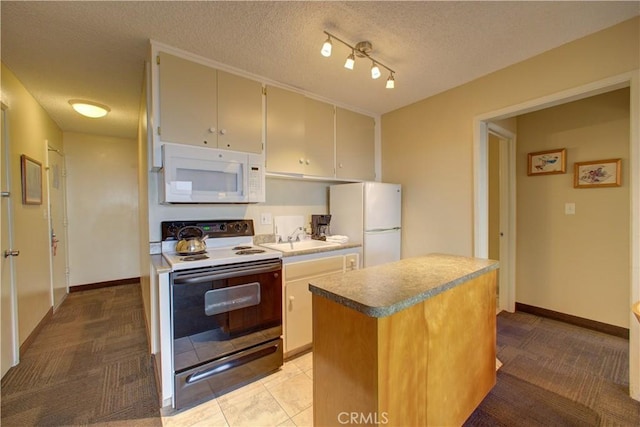 kitchen featuring a center island, white appliances, light carpet, sink, and a textured ceiling