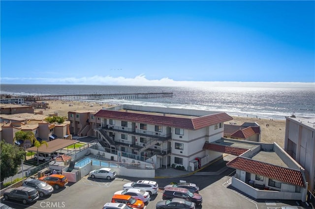 birds eye view of property featuring a beach view and a water view