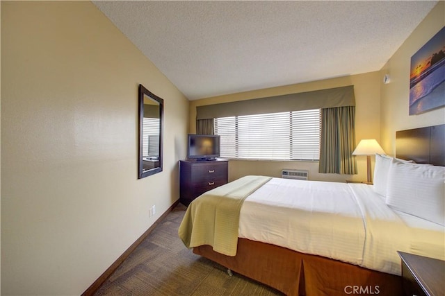 carpeted bedroom featuring a textured ceiling, vaulted ceiling, and a wall mounted AC