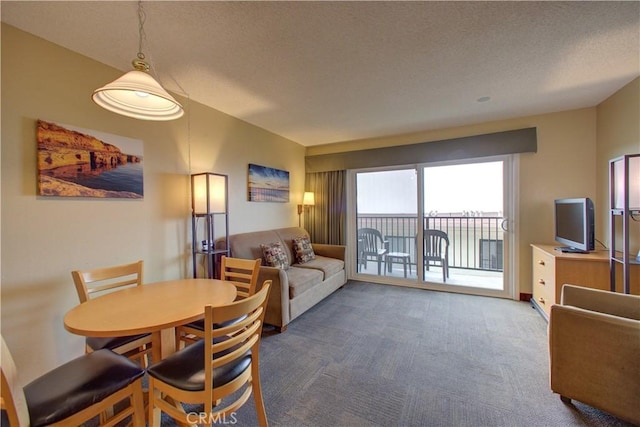 dining area featuring carpet and a textured ceiling