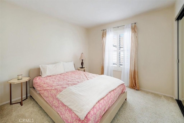 carpeted bedroom with multiple windows and a closet