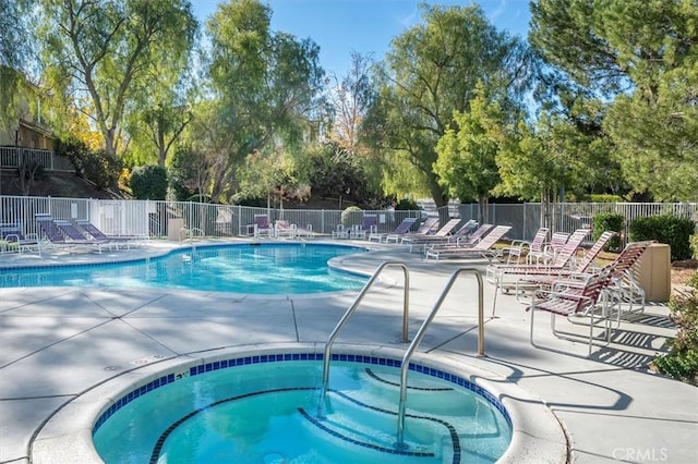 view of pool with a patio and a community hot tub