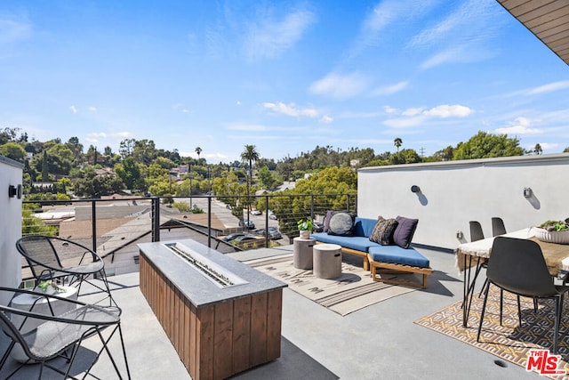 view of patio featuring an outdoor living space with a fire pit