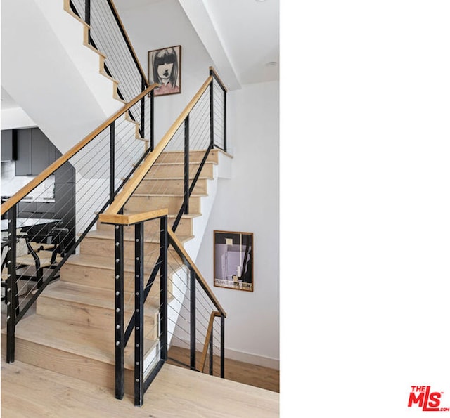 stairs featuring hardwood / wood-style flooring