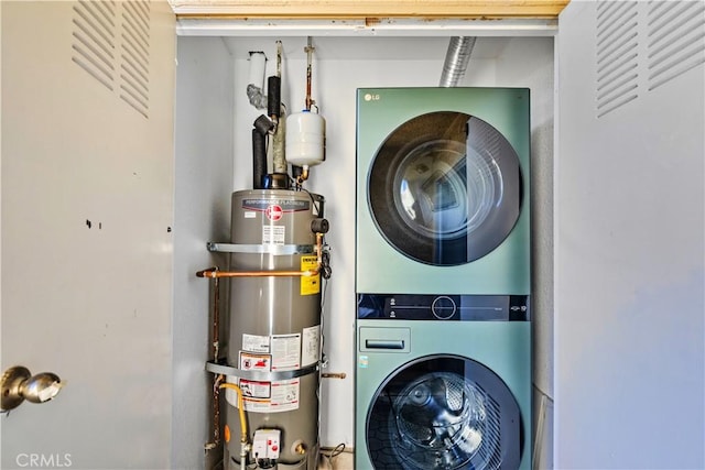 washroom featuring water heater and stacked washer and dryer